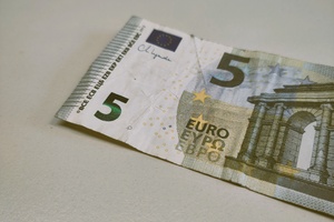 Zerknitterter 5-Euro-Schein auf neutralem, hellen Hintergrund