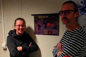 Wiebke Okken (links) steht mit Prof. Dr. Florian Hruby vor einer Kartografie.