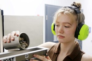 Frau füllt Granulat in eine Schiene