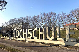 Betonbuchstaben auf dem Campus der Hochschule, Name "Beuth" verhüllt