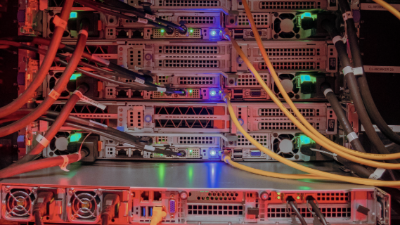 Blick in einen Serverraum mit vielen Kabeln, Buchsen und Lämpchen