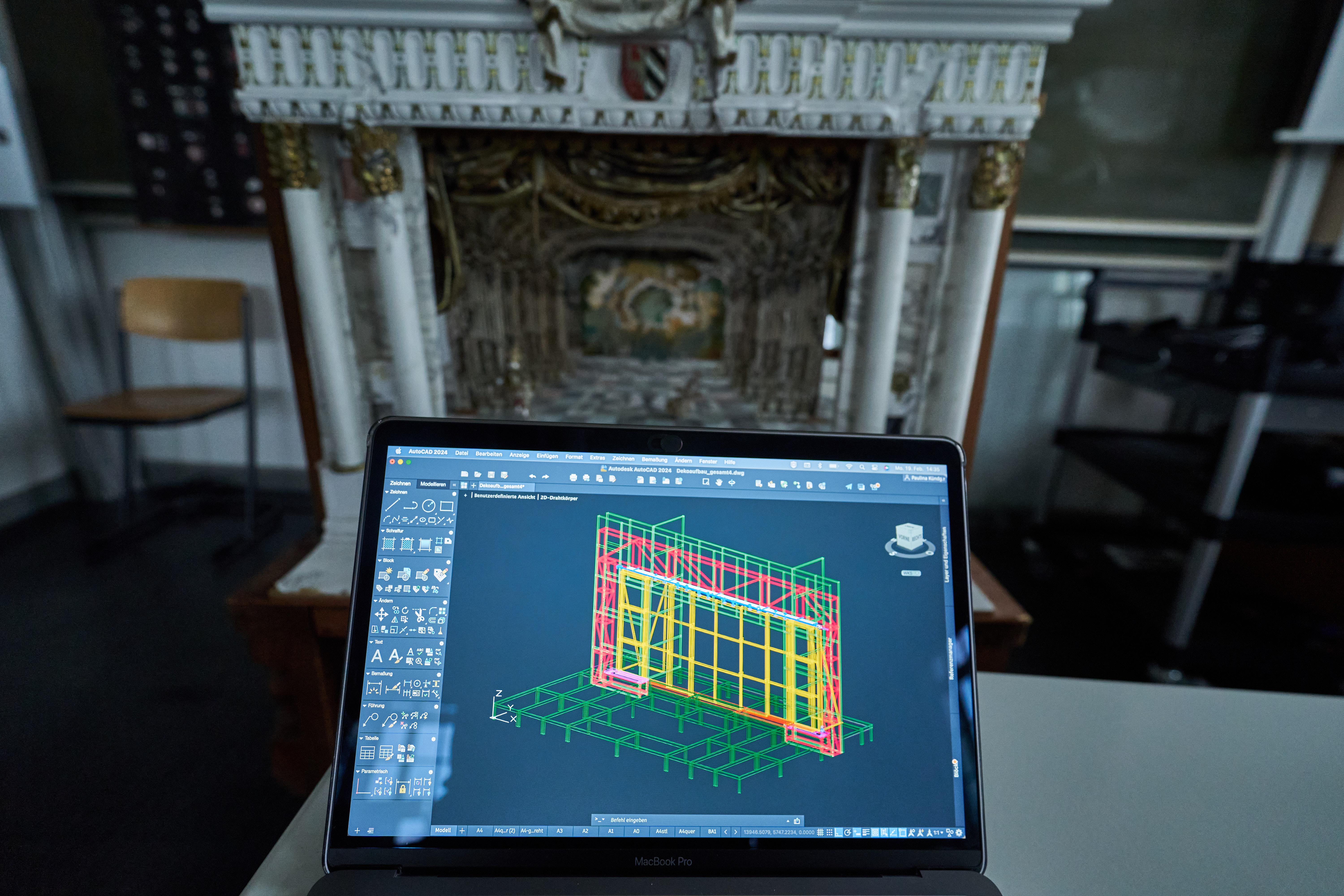 Ein Modell einer Bühne wird auf einem Laptop-Bildschirm als 2-D-Drahtkörper dargestellt, im Hintergrund ist das reale Modell zu sehen